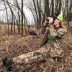 Hunter looking through binoculars