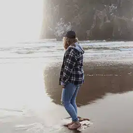 Woman walking along Oregon Coast