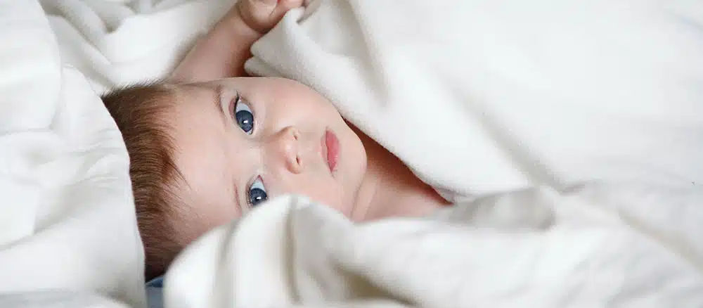 Baby playing in bed