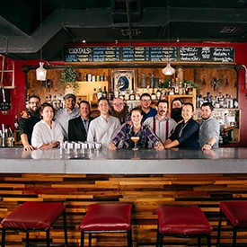 Hostel built into Austin Firehouse, team of happy employees behind bar